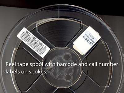 Reel tape spool with barcode and call number labels on spokes
